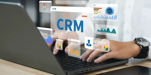 WhatsApp CRM automation dashboard displayed on a laptop, showing customer data, sales analytics, and workflow management for automated sales and follow-ups.